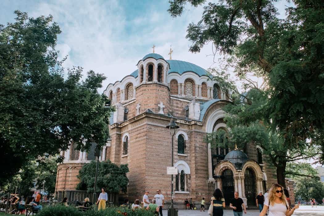 A majestic church surrounded by greenery, capturing architectural beauty and urban life.