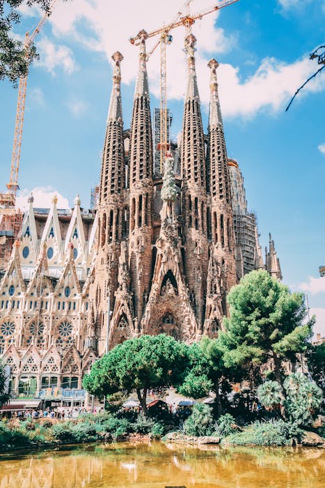 Iconic view of Sagrada Familia in Barcelona with clear blue skies, showcasing Gothic architecture.